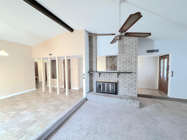 unfurnished living room with vaulted ceiling with beams, ceiling fan, and a brick fireplace