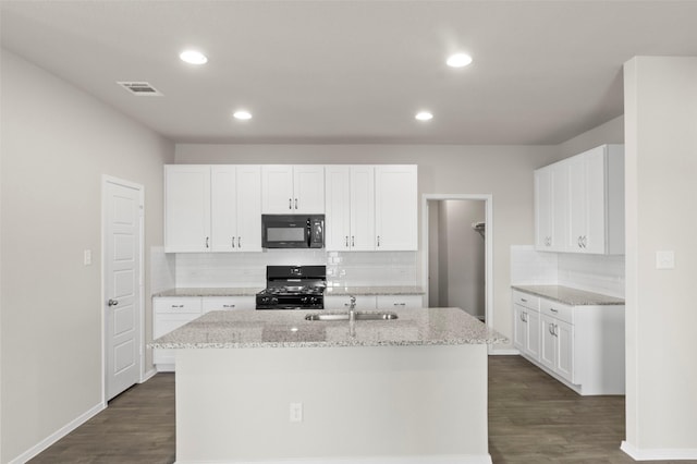 1906 Sweetwater Dr, Forney, TX 75126 - kitchen with visible vents, dark wood-type flooring, an island with sink, black appliances, and a sink