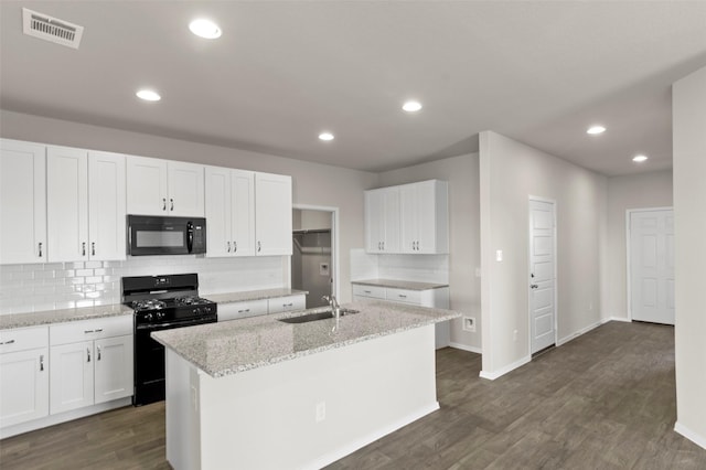 1906 Sweetwater Dr, Forney, TX 75126 - kitchen with dark wood-style floors, visible vents, a sink, black appliances, and white cabinetry