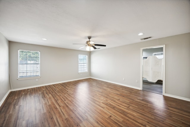 spare room featuring ceiling fan and dark wood-type flooring