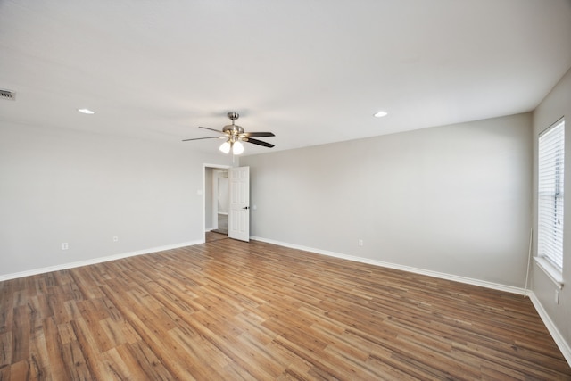 unfurnished room with ceiling fan and hardwood / wood-style flooring