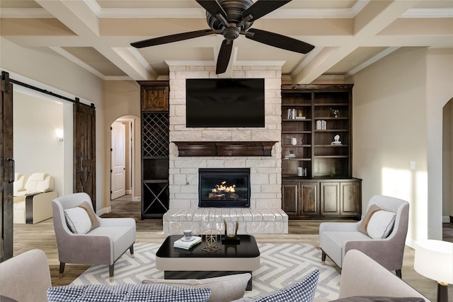 living room with ceiling fan, beamed ceiling, and coffered ceiling