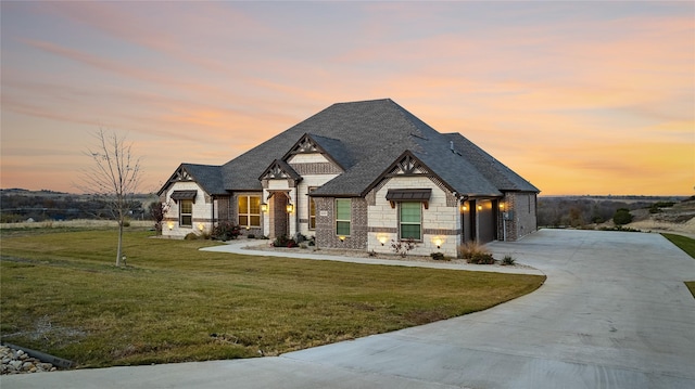 view of front of house with a lawn and a garage