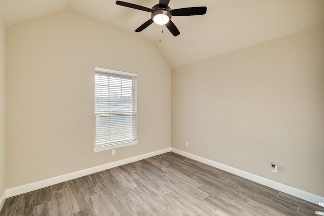 empty room with ceiling fan, light hardwood / wood-style floors, and lofted ceiling