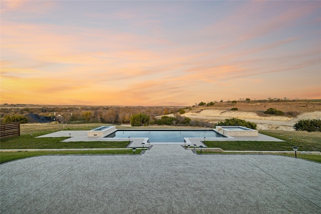 pool at dusk with a yard