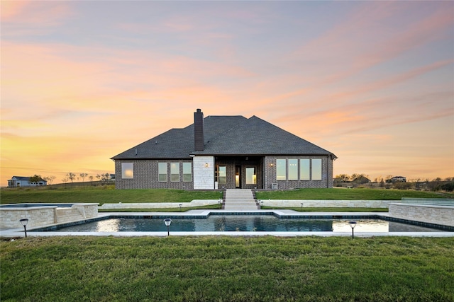 back house at dusk with a yard