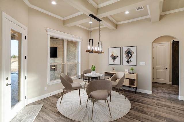 dining space featuring beam ceiling, hardwood / wood-style flooring, crown molding, and coffered ceiling