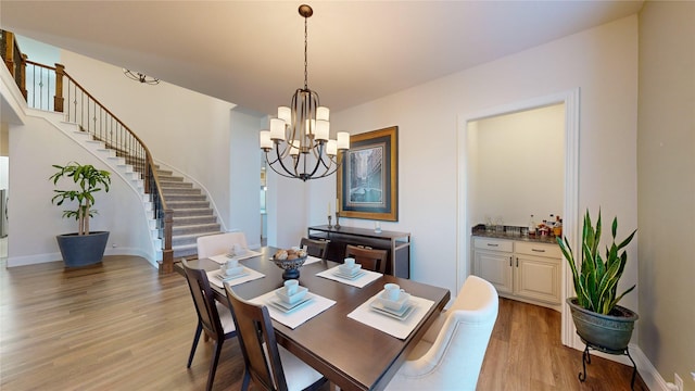 dining area with an inviting chandelier and light wood-type flooring