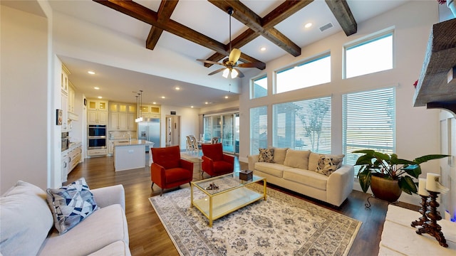 living room featuring dark wood-type flooring, coffered ceiling, sink, ceiling fan, and beamed ceiling