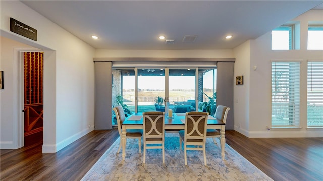 dining space featuring dark hardwood / wood-style floors and a healthy amount of sunlight