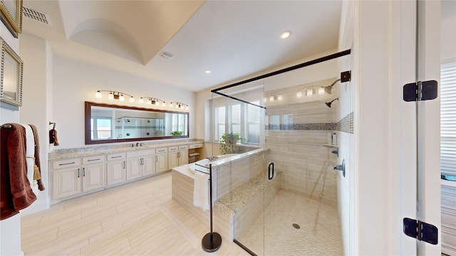 bathroom featuring plenty of natural light, vanity, independent shower and bath, and tile patterned flooring