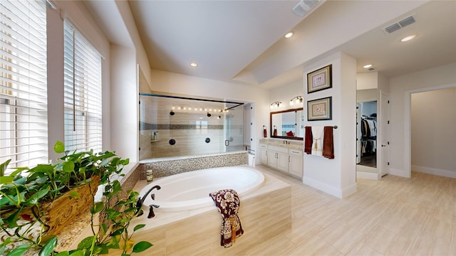 bathroom featuring vanity and shower with separate bathtub