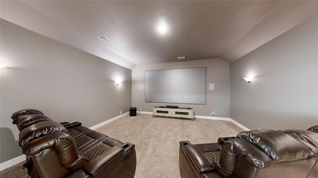 cinema with carpet floors and lofted ceiling