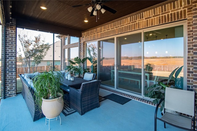 sunroom with ceiling fan and wood ceiling