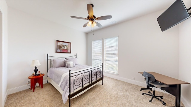 carpeted bedroom with ceiling fan and multiple windows