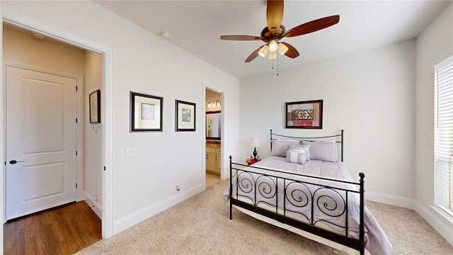 bedroom with hardwood / wood-style flooring, ceiling fan, and connected bathroom