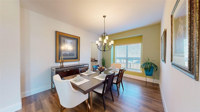 dining area with dark hardwood / wood-style floors and an inviting chandelier