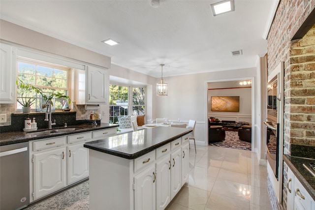 kitchen featuring backsplash, stainless steel appliances, white cabinetry, and sink