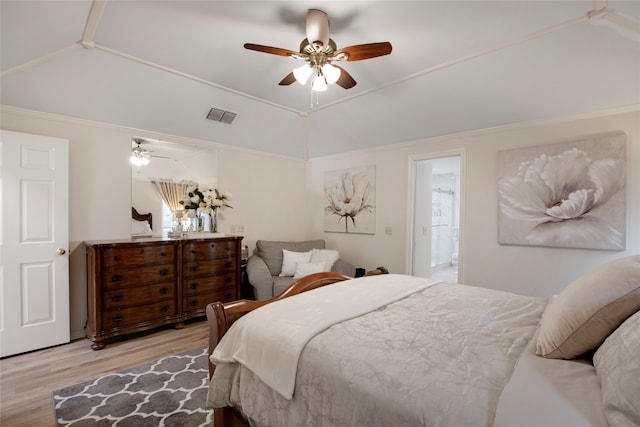 bedroom with ceiling fan, ensuite bathroom, light hardwood / wood-style floors, and vaulted ceiling