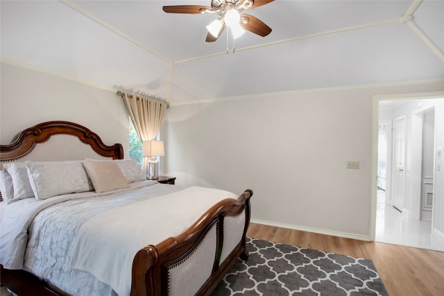 bedroom featuring hardwood / wood-style floors, ceiling fan, and vaulted ceiling