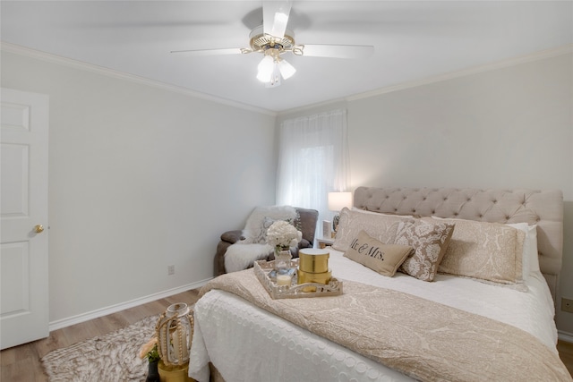 bedroom with ceiling fan, hardwood / wood-style floors, and ornamental molding