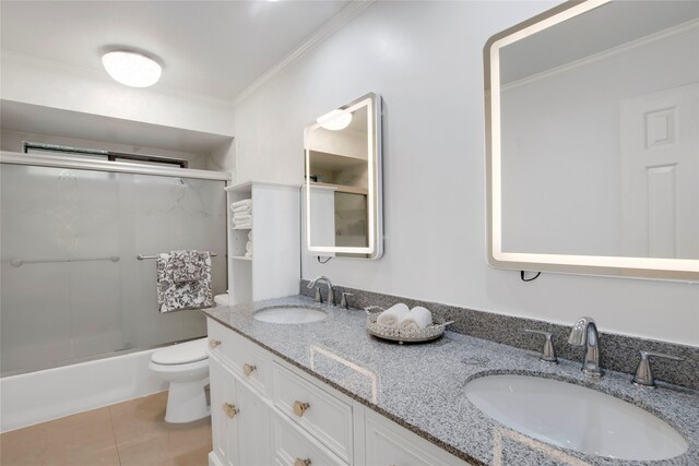 full bathroom featuring tile patterned flooring, toilet, shower / bath combination with glass door, vanity, and ornamental molding