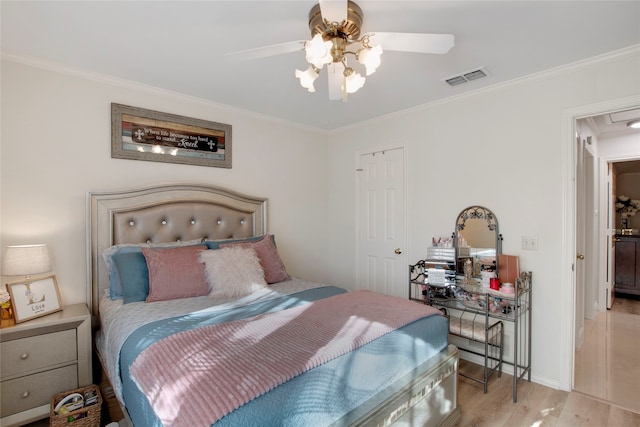 bedroom featuring ceiling fan, crown molding, and light wood-type flooring