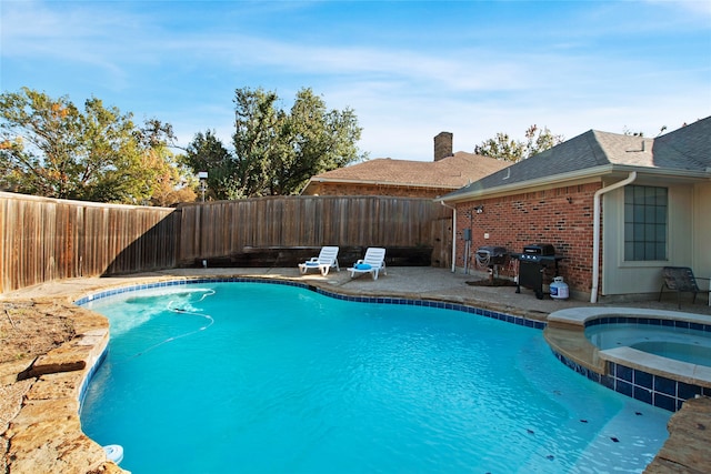 view of pool with a grill, an in ground hot tub, and a patio area