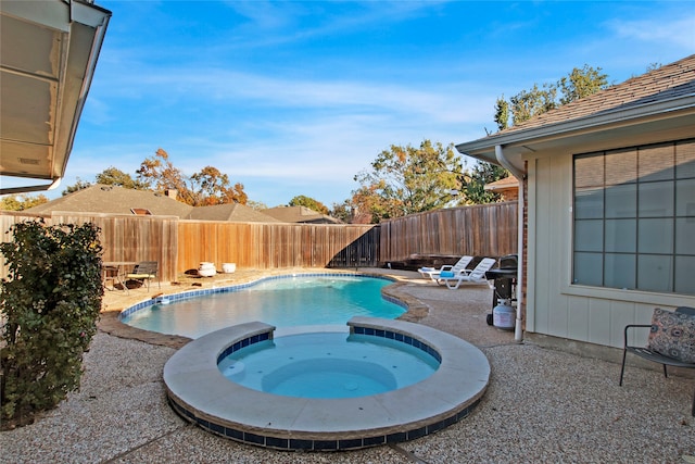 view of pool featuring an in ground hot tub and a patio area