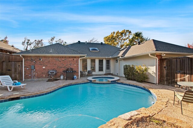 view of pool with grilling area, an in ground hot tub, and a patio