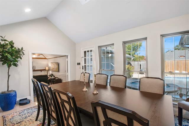 dining area featuring ceiling fan and high vaulted ceiling