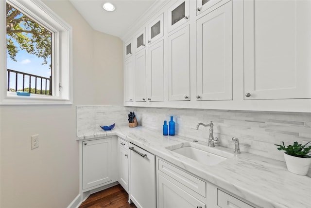 kitchen featuring dark wood-type flooring, white cabinetry, sink, and light stone countertops