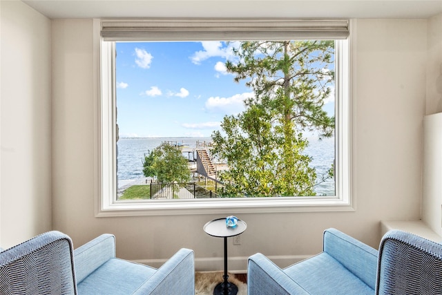 sitting room featuring a wealth of natural light and a water view