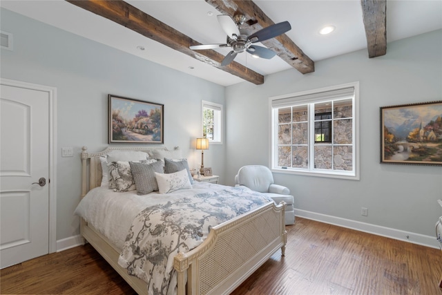 bedroom with ceiling fan, beam ceiling, and dark wood-type flooring