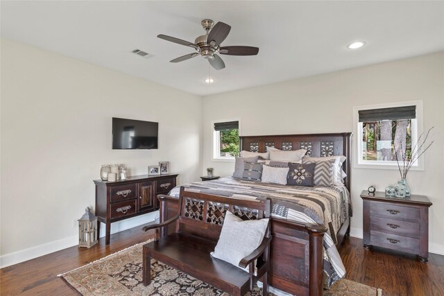 bedroom featuring multiple windows, ceiling fan, and dark wood-type flooring