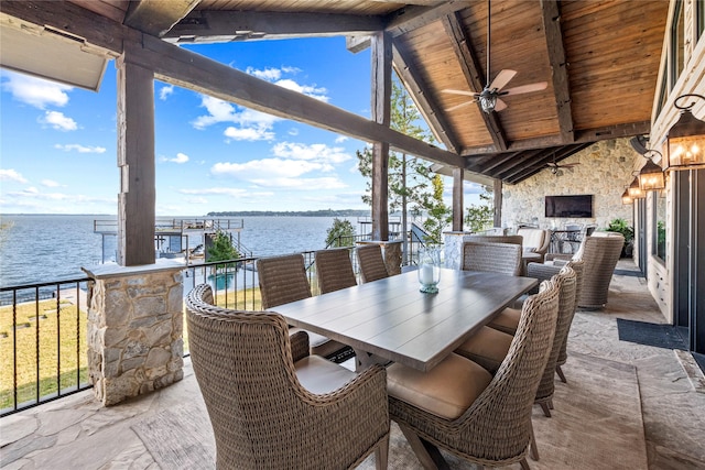 view of patio with ceiling fan and a water view