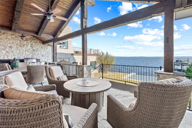 exterior space with a water view and ceiling fan