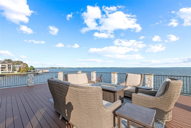 wooden deck featuring a water view and an outdoor fire pit