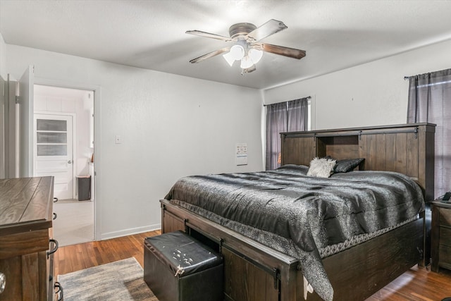 bedroom featuring hardwood / wood-style flooring and ceiling fan