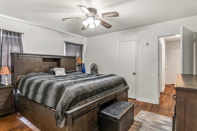 bedroom with ceiling fan and dark wood-type flooring