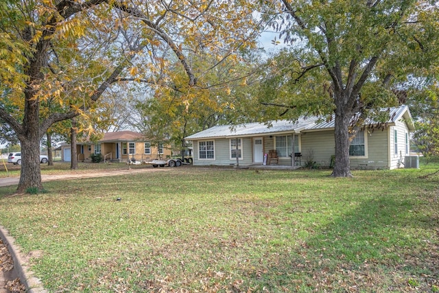 view of front of house featuring a porch, central air condition unit, and a front yard