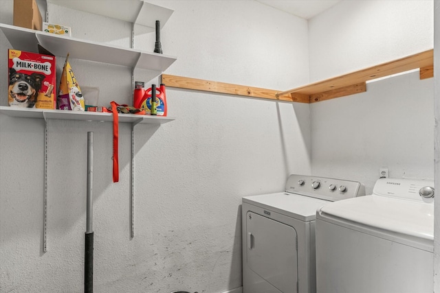 clothes washing area with separate washer and dryer