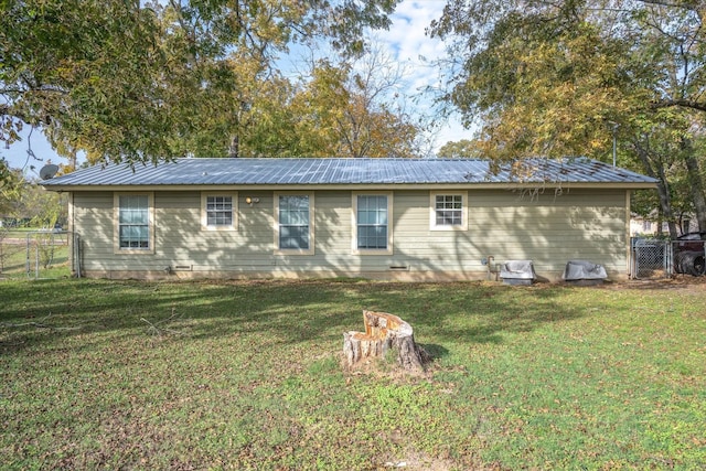 back of house with a lawn