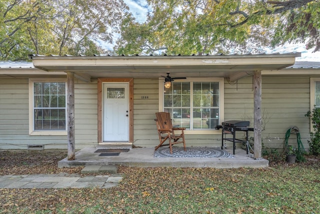 view of exterior entry featuring covered porch