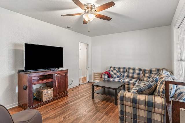 living room with hardwood / wood-style floors and ceiling fan