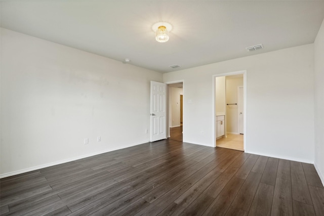 unfurnished bedroom with connected bathroom and dark hardwood / wood-style flooring