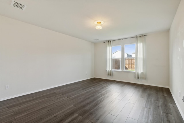 empty room with dark wood-type flooring