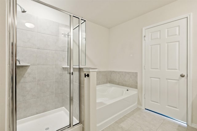 bathroom with tile patterned floors and independent shower and bath