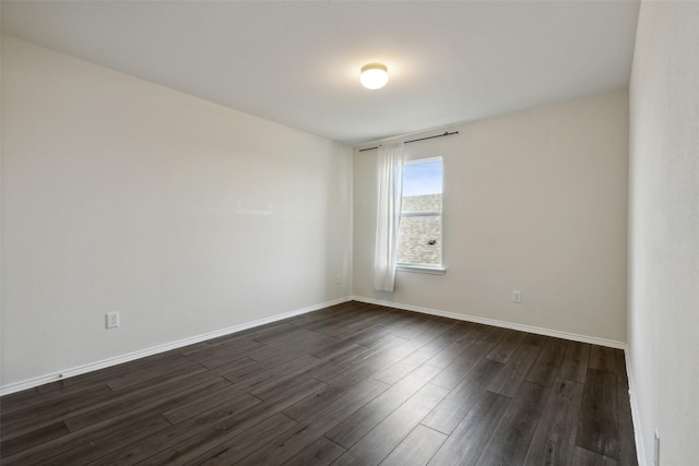 unfurnished room with dark hardwood / wood-style floors