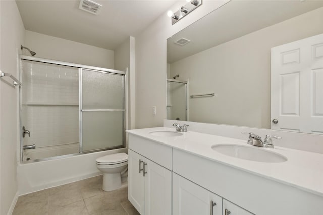 full bathroom featuring tile patterned floors, toilet, vanity, and combined bath / shower with glass door